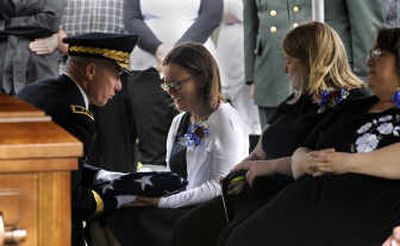 
Raechel Caldwell, wife of Chad Caldwell, who was killed in Iraq, accepts the flag from his casket from Maj. General Edgar E. Stanton III at the grave site at Spokane Memorial Gardens Saturday. The Cheney native was killed by a roadside bomb in Mosul, Iraq April 30. 
 (PHOTOS BY JESSE TINSLEY / The Spokesman-Review)