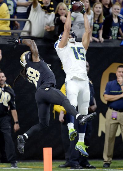 Seahawks wide receiver Jermaine Kearse (15) leaps to catch pass over B.W. Webb but was unable to stay in bounds in the end zone on the final play of Sunday’s game. (Bill Feig / Associated Press)
