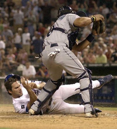 
Texas' Mark DeRosa is tagged out at home by Seattle catcher Yorvit Torrealba in the fifth.
 (Associated Press / The Spokesman-Review)