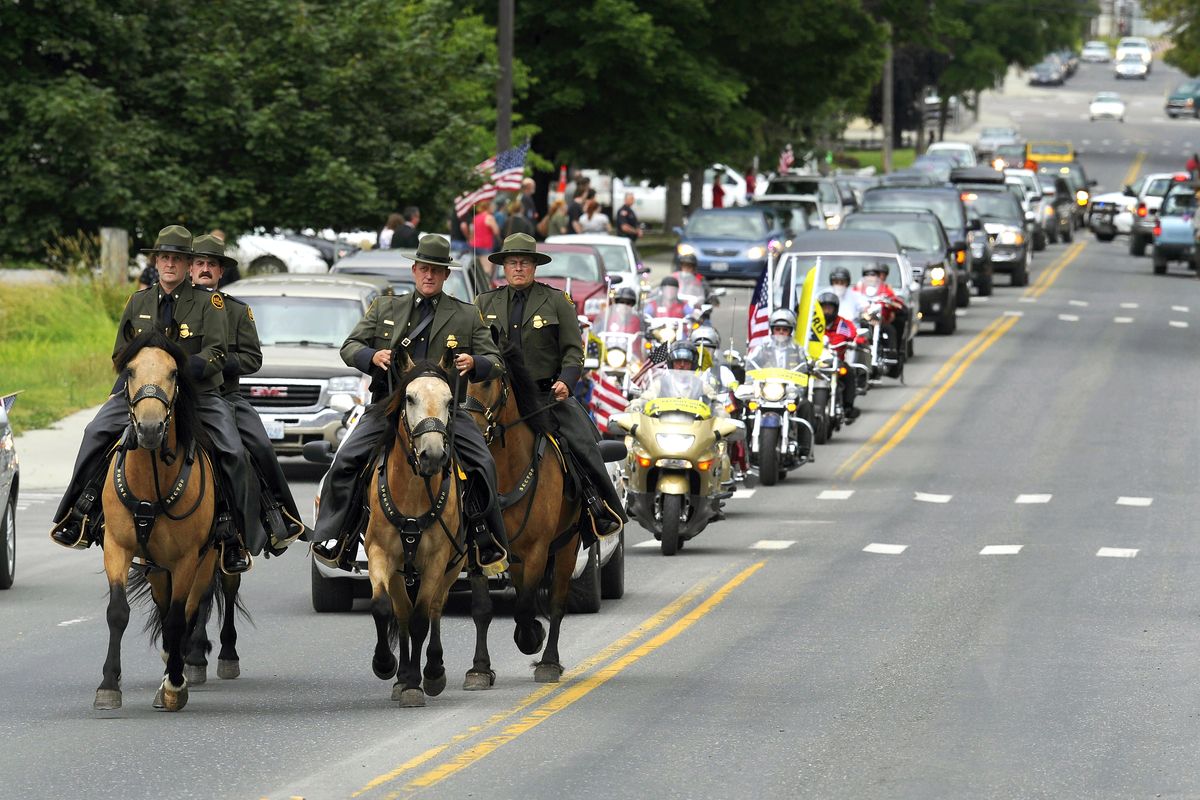 After the funeral at Immaculate Conception Catholic Church, the U.S. Border Patrol and the Patriot Guard escort the body of Staff Sgt. Wyatt Goldsmith to his final resting place at Mountain View Cemetery in Colville on Tuesday. (Colin Mulvany)