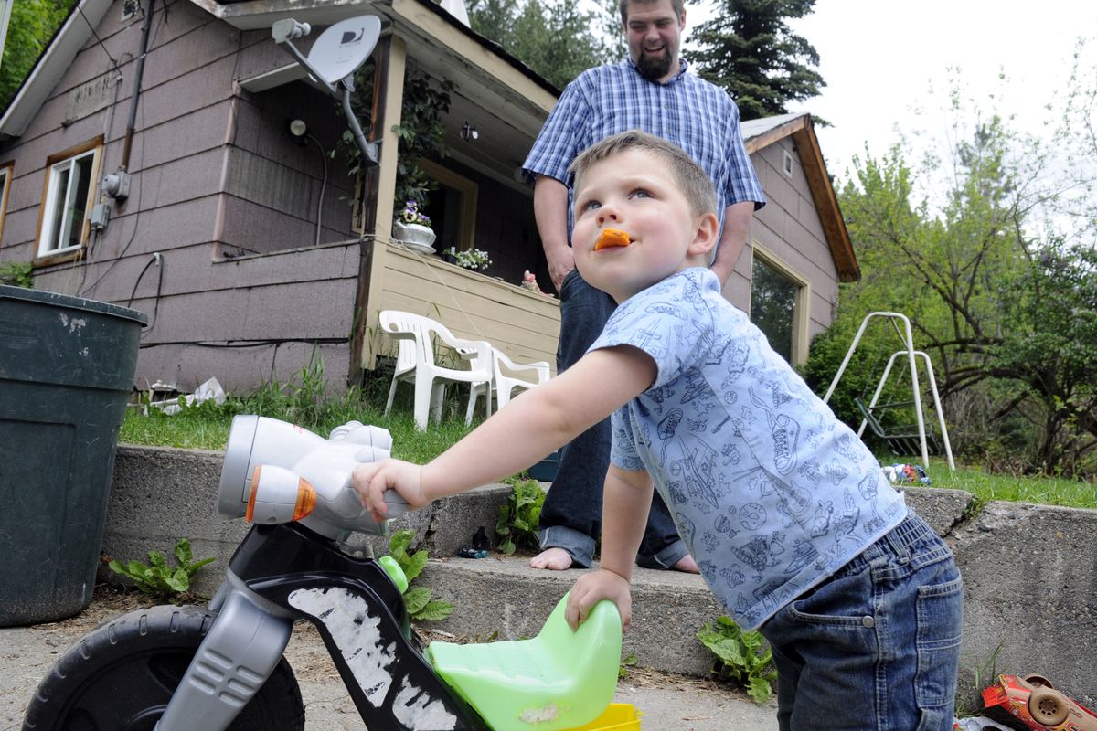 Shane Stancik watches his son, 3-year-old Shane Jr., play in front of their Silver Valley home Tuesday. Stancik participated in a study about attitudes toward blood-lead testing. He wants to make regular screening for his son a priority.  jesset@spokeman.com (JESSE TINSLEY jesset@spokeman.com)