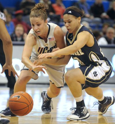 UConn’s Caroline Doty, left, and Skylar Diggins chase loose ball. (Associated Press)