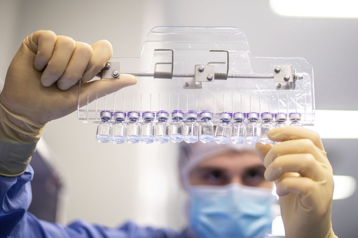 A technician inspects filled vials of the Pfizer-BioNTech COVID-19 vaccine at the company’s facility in Puurs, Belgium, in March. Pfizer and Moderna have filed FDA applications for booster doses, but the government will decide on extra Johnson & Johnson doses later once that company shares its booster data with the agency.  (Courtesy of Pfizer)