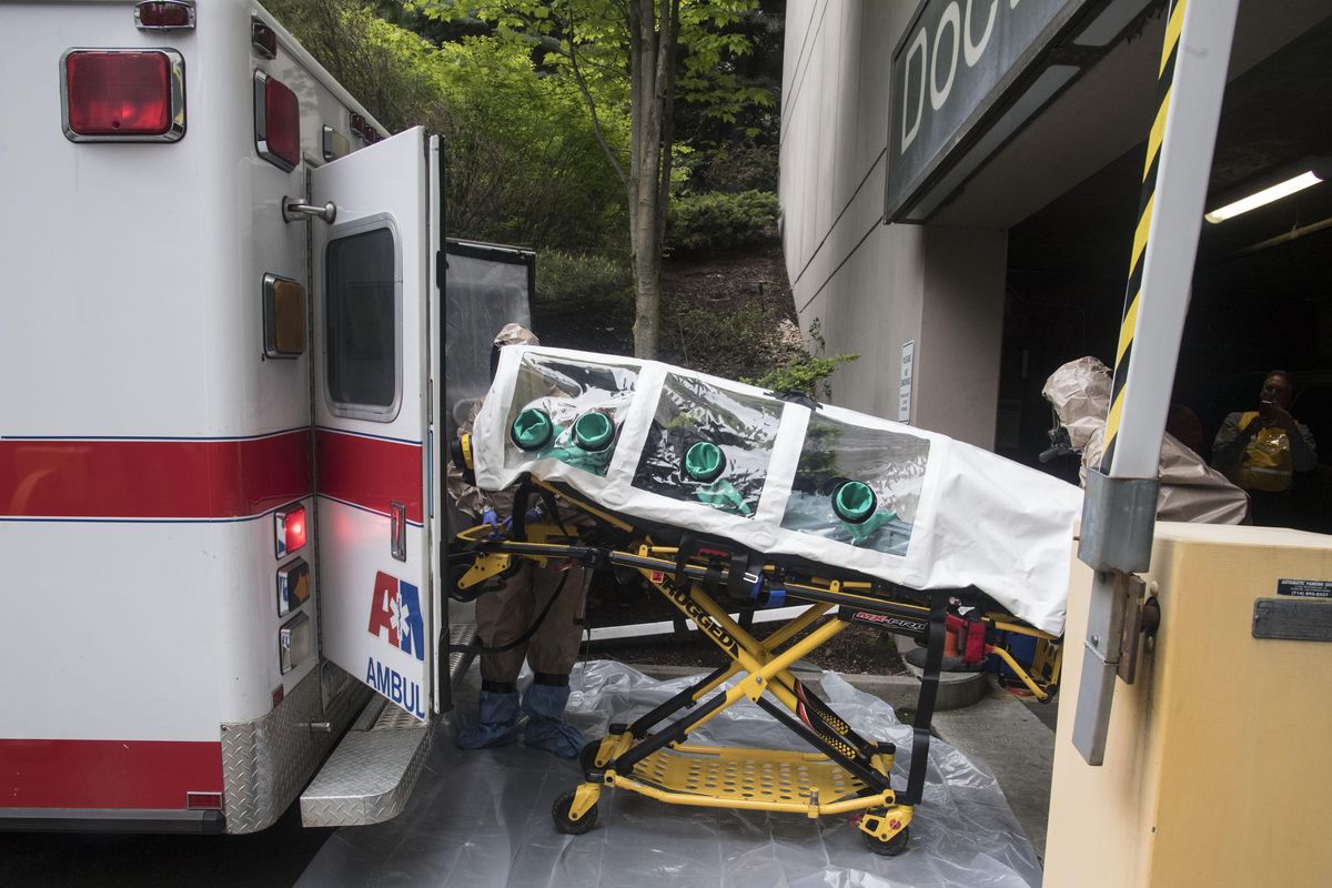 A mock patient suspected of being exposed to Ebola is unloaded from an AMR Ambulance to Providence Sacred Heart Medical Center, May 17, 2017. (Dan Pelle / The Spokesman-Review)