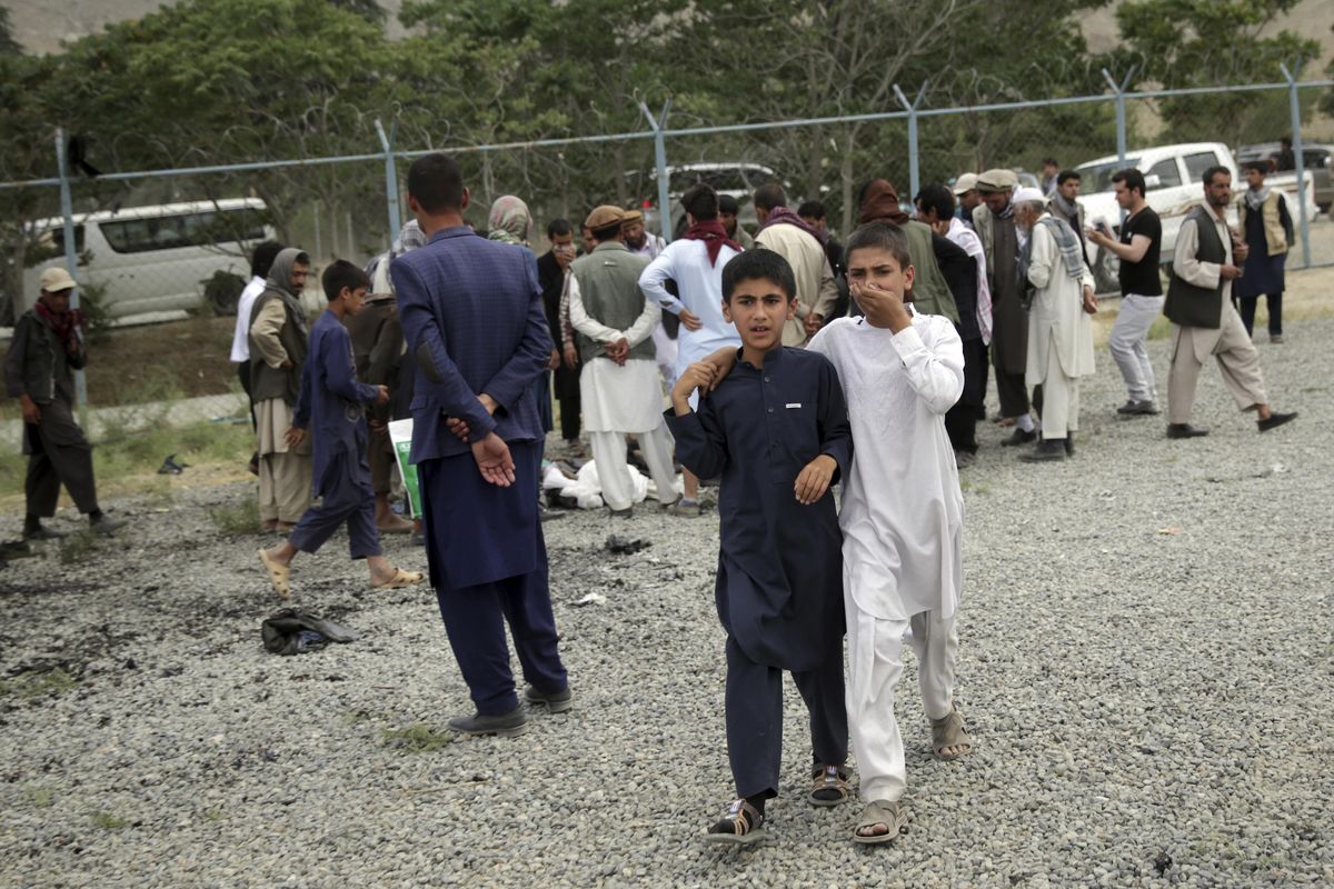 Boys walk away from the site of three suicide attacks during a funeral ceremony, in Kabul, Afghanistan, Saturday, Jun 3, 2017. Explosions in Kabul on Saturday killed at least six people attending a funeral reportedly attended by government officials, including members of parliament, a day after hundreds of demonstrators turned out to demand more security in the capital. (Massoud Hossaini / Associated Press)