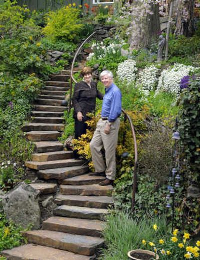 
Linda, left, and Jim Hunt stand on the garden steps between their home and 