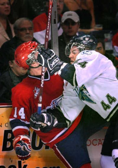 
Chiefs center Mitch Wahl, left, gets a facefull of gear from Blades defenseman John Flatters. The Spokesman Review
 (BRIAN PLONKA The Spokesman Review / The Spokesman-Review)