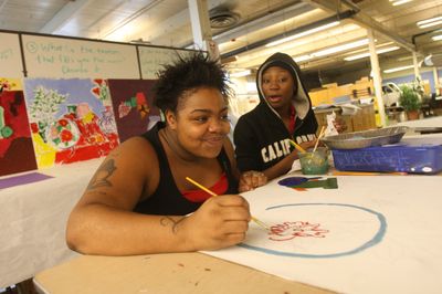Students Lanisha Secrest, 17, left, and Briana Manson, 15, both of Seattle, work on still-life paintings at Opportunity Skyway at Boeing Field in Seattle on Wednesday.  (Associated Press / The Spokesman-Review)