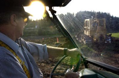 Ray LaBoure checks out the work being done by Wittkopf Landscaping on the 27-acre wetlands project on LaBoure's property on the north end of Hauser Lake Thursday.
(The Spokesman-Review)