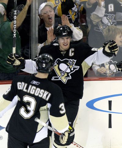 Pittsburgh’s Sidney Crosby, center, celebrates his goal with teammate Alex Goligoski against the Florida Panthers. (Associated Press / The Spokesman-Review)