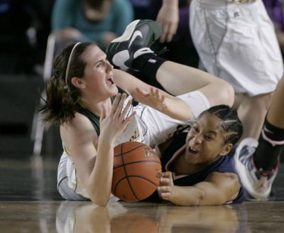 Shadle Park's Amanda Carlton, left, calls for a time-out as she battles Kennedy's Andrea Goins for a lose ball during the second quarter of the Girls Washington 3A high school basketball championship game in Tacoma on Saturday. The Highlanders came up short against the Lancers, falling 50-43. (John Froschauer / The Associated Press)