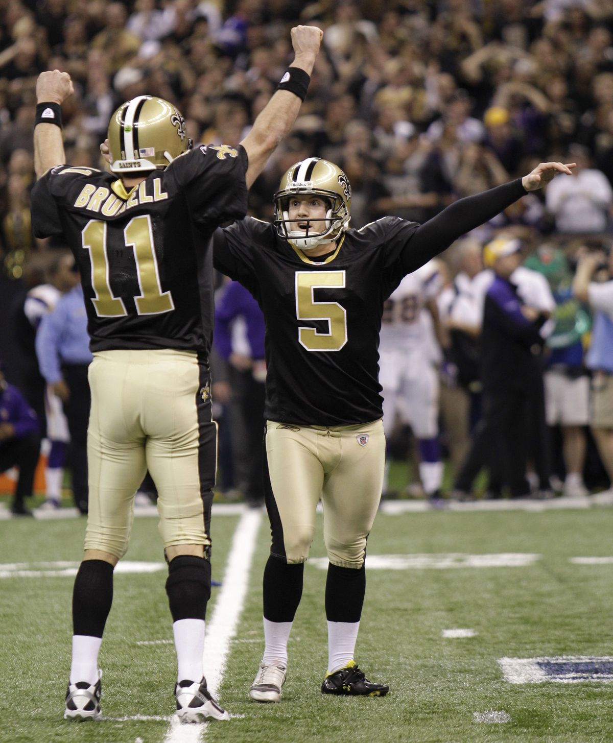 Saints kicker Garrett Hartley celebrates with Mark Brunell after kicking the winning field goal during overtime of the NFC Championship.  (Associated Press)