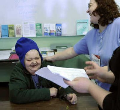 
AARP Tax-Aide volunteer Brittlyn Bourassa, right, helps Verena Warnock on  Saturday at the YWCA Free Tax Preparation Site.   
 (Dan Pelle / The Spokesman-Review)