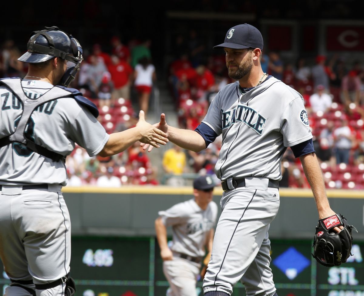 M’s closer Tom Wilhelmsen gets victory shake from catcher Mike Zunino. (Associated Press)
