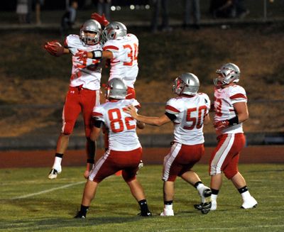 Ferris' Kurtis Karstetter, left, flies high in celebration with teammate Kole Heidinger after Karstetter scored the only Ferris touchdown of the first half, Friday, Sept. 30, 2011, at Central Valley High School.  Also pictured are Carson Fuller (82), Chris Beaulaurier (50) and Max Lee (53). The two GSL contenders ended the first half 10-7, CV edging the Saxons. (Jesse Tinsley / The Spokesman-Review)