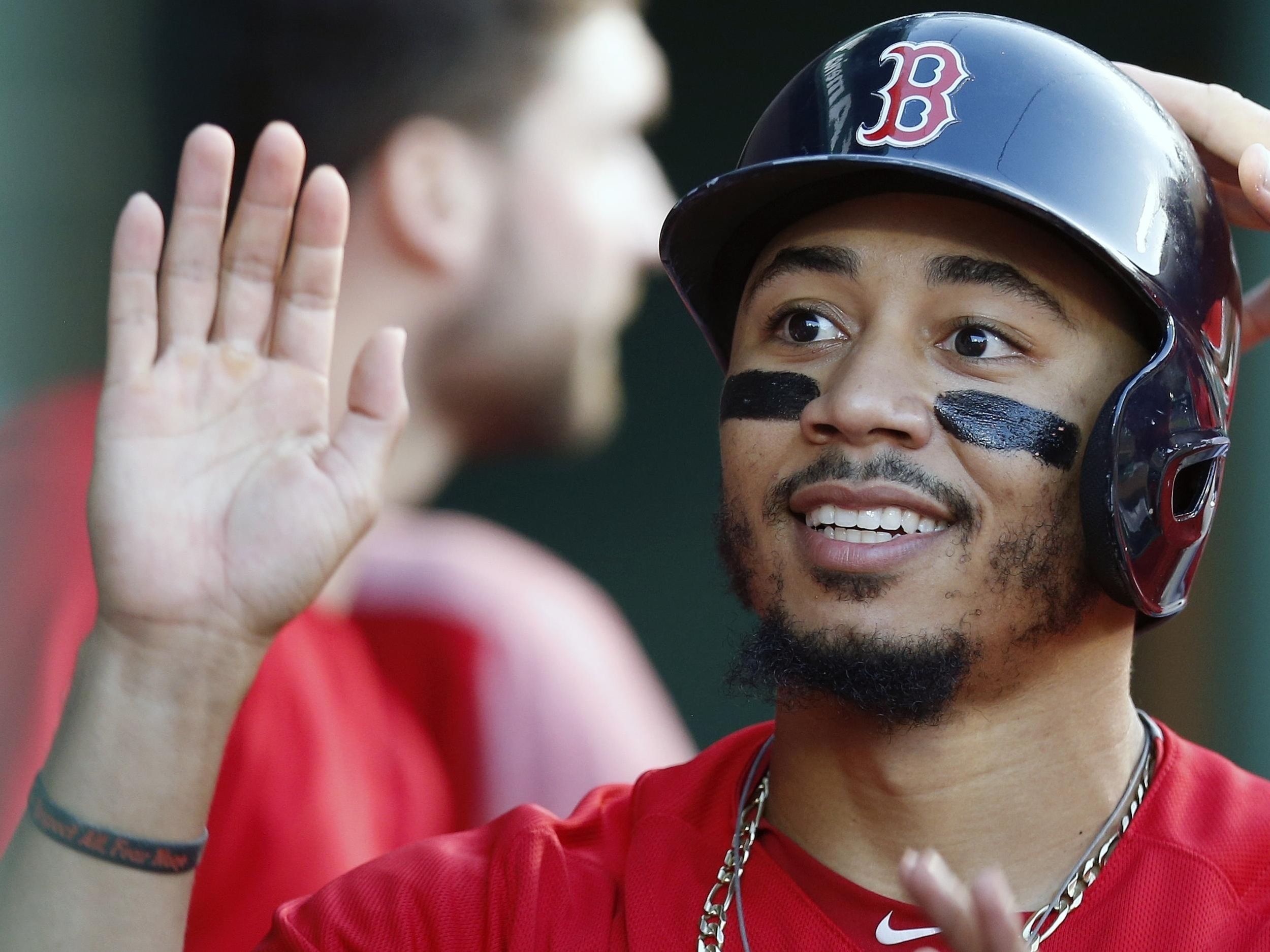 A detail shot of the necklace worn by Mookie Betts of the Boston