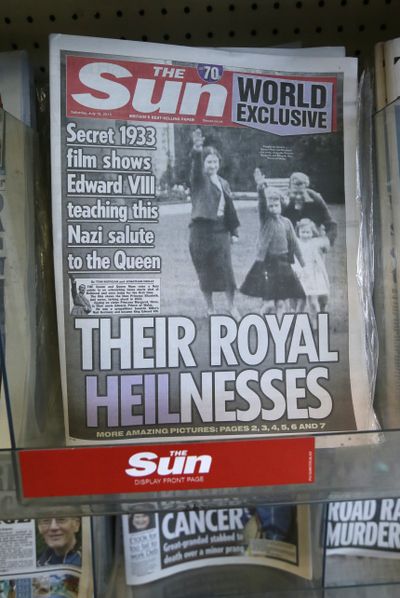 Newspapers are on display including a paper with a photo of Britain’s Queen Elizabeth as a child giving a Nazi salute, in a shop in London on Saturday. (Associated Press)