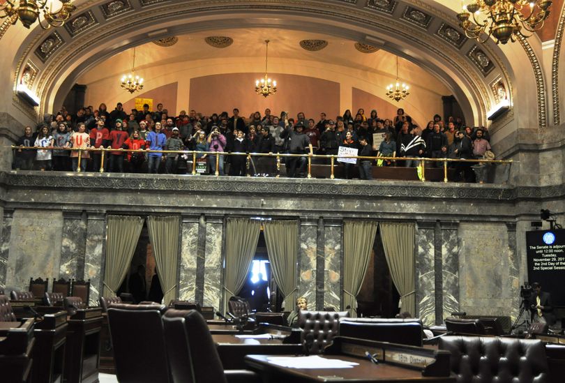 Sen Karen Fraser, D-Olympia, is the only senator in the chamber as Occupy protesters chant from the gallery. (Jim Camden)