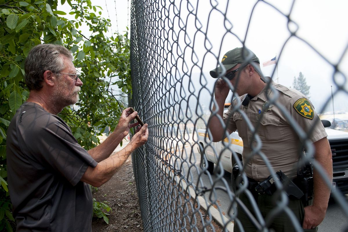 “Did this one make it?” Dave Hamilton asked as he showed Kootenai County sheriff’s Deputy Justin Arts a photograph of his home in Bayview.