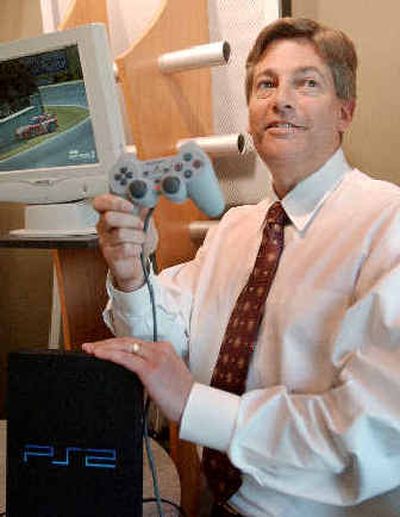 
Immersion Chief Executive Victor Viegas holds up a Sony Corp. PlayStation2 game controller at company headquarters in San Jose, Calif., on Monday. 
 (Associated Press / The Spokesman-Review)