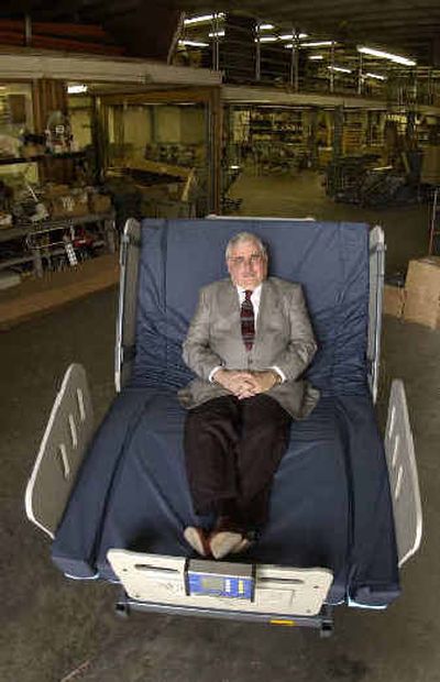 
DuWayne Kramer, president of Burke Mobility Products, sits in a bed designed for people weighing up to 1,000 pounds, which his company builds at their Kansas City, Kan. manufacturing plant. 
 (Associated Press / The Spokesman-Review)