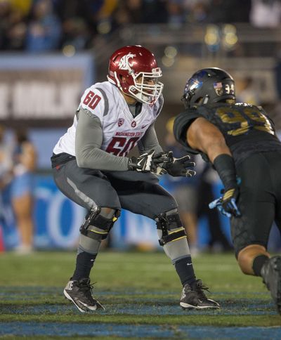 Washington State left tackle Andre Dillard, left, considered himself a basketball player at Woodinville (Washington) High School. (Jeff Lewis / Associated Press)