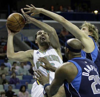 
New Orleans' Peja Stojakovic, left, shoots over Dallas' Erick Dampier (25) and Dirk Nowitzki.Associated Press
 (Associated Press / The Spokesman-Review)