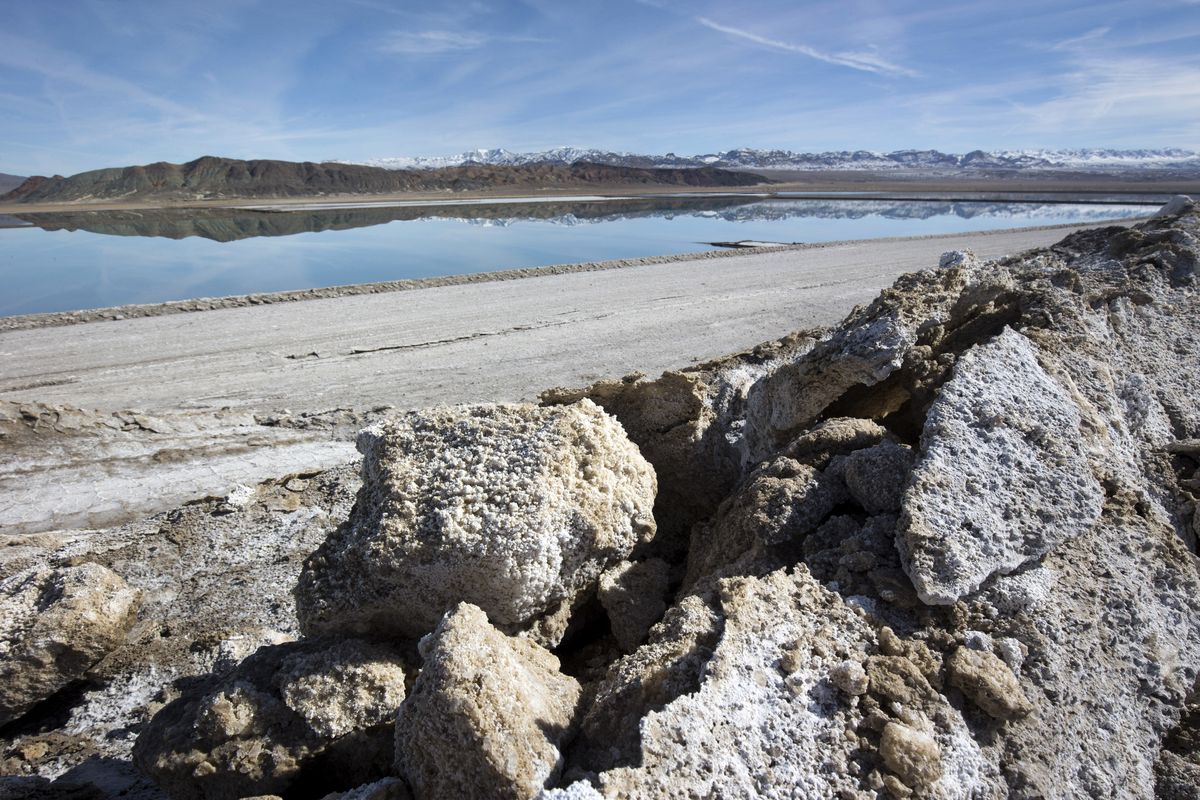 In this Jan. 30, 2017 photo, waste salt, foreground, is shown near an evaporation pond at the Silver Peak lithium mine near Tonopah, Nev. The Trump administration granted final approval for a proposed northern Nevada lithium mine, one of several eleventh-hour moves made by the Department of Interior to greenlight mining and energy projects. Unlike some other approvals, which are likely to be revoked, President Biden has voiced support for lithium mining as part of his clean energy plans.  (Steve Marcus)