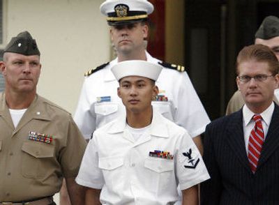 
Navy Petty Officer 3rd Class Melson J. Bacos, center, is escorted into his court-martial by his defense attorneys at Camp Pendleton Marine Corps Base, Calif., on Friday. 
 (Associated Press / The Spokesman-Review)