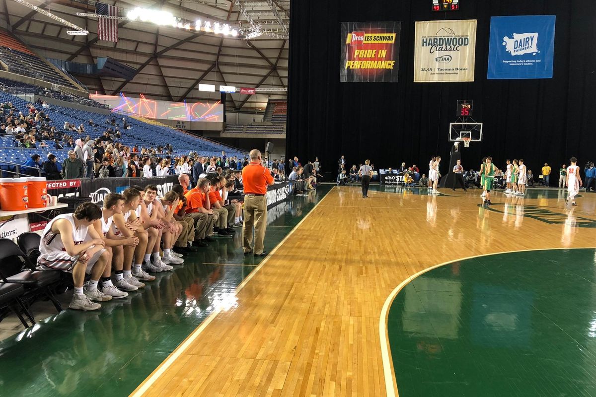 Lewis and Clark coach Jim Redmon, center, watches his team in the fourth quarter of its state 4A third-place game against Richland on Saturday, March 3, 2018 at the Tacoma Dome. (Dave Nichols / The Spokesman-Review)