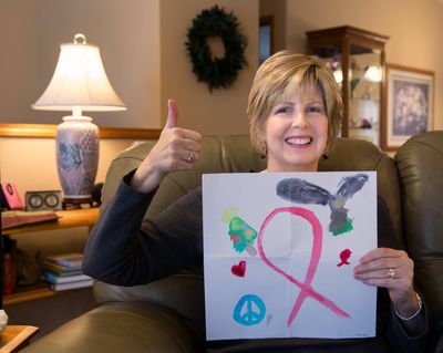 Chan, in her blond wig, holds a picture drawn for her by Max Hein, the 7-year-old son of friends Mark and Lori Hein of Lake Stevens, Wash.