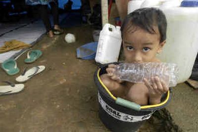
Rohim Asram, 4, bathes in a bucket Friday at a refugee camp in Mata Ei, Aceh, Indonesia. 
 (Associated Press / The Spokesman-Review)