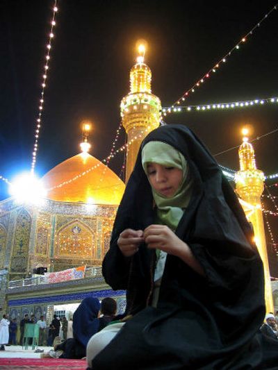 
A girl prays with prayer beads on the first day of Ramadan at the Shiite holy shrine of Imam Ali, in Najaf, 100 miles south of Baghdad. 
 (Associated Press / The Spokesman-Review)
