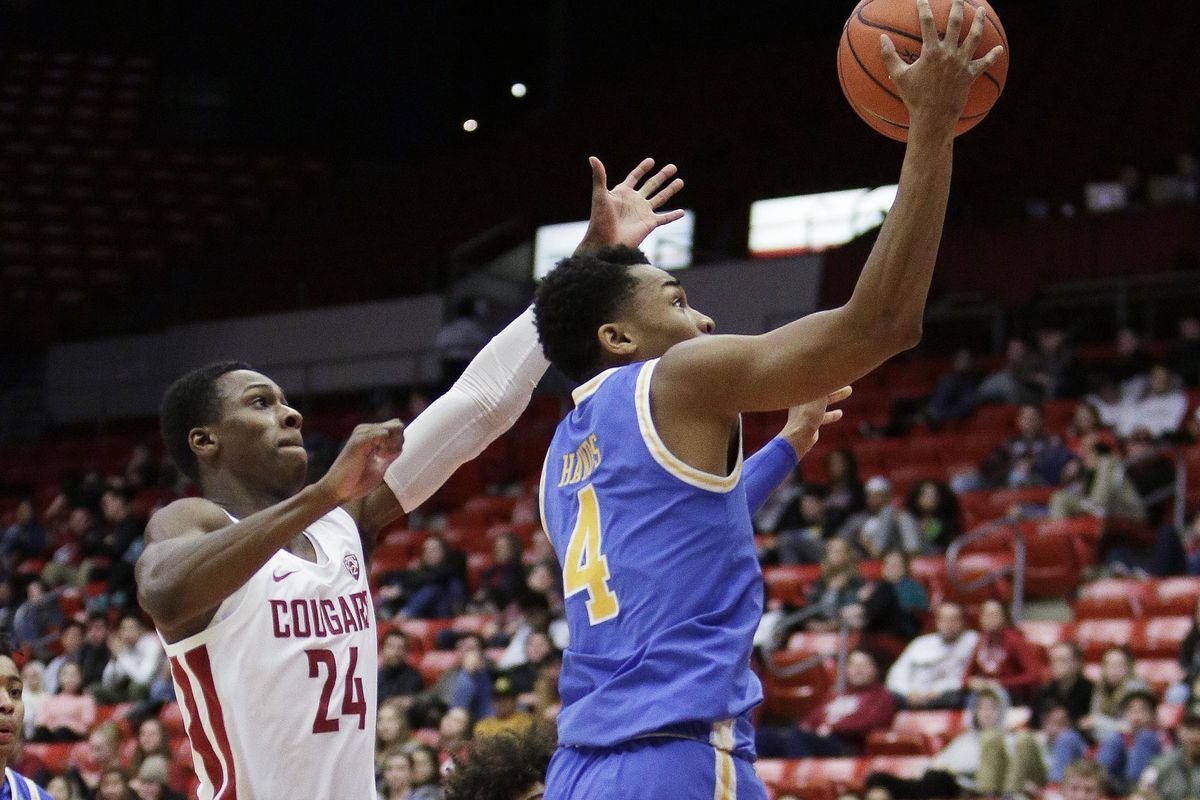 UCLA guard Jaylen Hands  shoots in front of Washington State guard Viont’e Daniels  during the second half Wednesday in Pullman. (Young Kwak / AP)