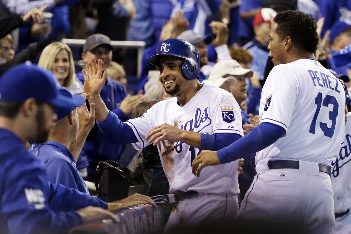 Royals’ Omar Infante is all smiles after scoring from first base on a double by Alcides Escobar in the fifth inning for a 9-0 lead over the Giants. (Associated Press)