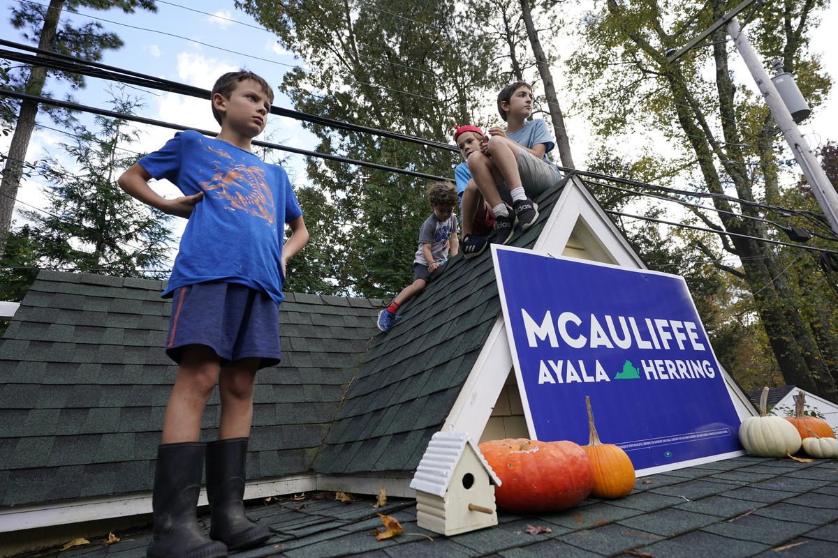 Kids watch the proceedings from the roof of a playhouse as Democratic gubernatorial candidate former Virginia Gov. Terry McAuliffe speaks to supporters during a rally in Richmond, Va., Sunday, Oct. 31, 2021. McAuliffe will face Republican Glenn Youngkin in the November election.  (Steve Helber)