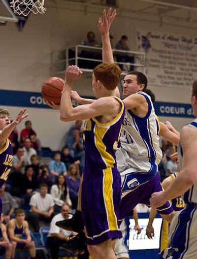 
Lewiston's Peter Gregg, center, fouls Coeur d'Alene's Jon Latorre during first-half play Saturday night. Special to 
 (Bruce Twitchell photos Special to / The Spokesman-Review)