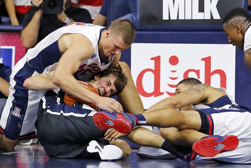 Arizona center Kaleb Tarczewski, left, and Brandon Ashley fight for the ball with Gonzaga guard Kevin Pangos, center, during overtime in an NCAA college basketball game Saturday, Dec. 6, 2014, in Tucson, Ariz. (David Kadlubowski / The Arizona Republic)