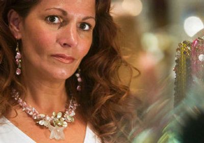 
Deena Moe-Caruso, owner of Finders Keepers, models a custom-designed necklace and earrings made with various shades of pearls. 
 (Kathryn Stevens / The Spokesman-Review)