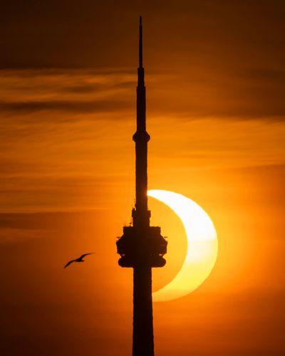 The sun rises behind the skyline during an annular eclipse on June 10, 2021, in Toronto, Canada.  (Mark Blinch)