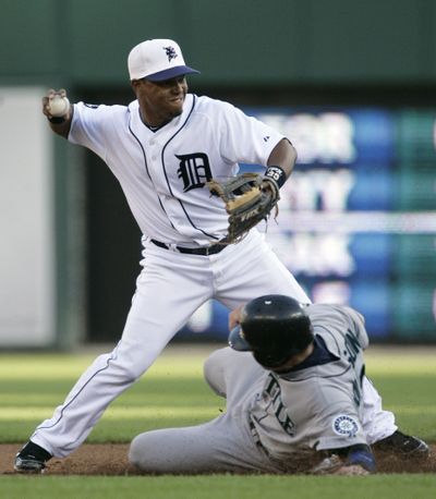 Detroit Tigers shortstop Ramon Santiago throws to first after getting a force out on Seattle Mariners' Rob Johnson in the third inning, but Ichiro Suzuki beat the throw. (Duane Burleson / Fr38952 Ap)