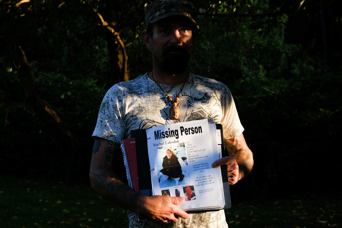 Carlton “Bud” Carr Jr. poses for a photo on Monday, Aug. 23, 2021, in the backyard of his home in Concrete, Wash Carr is holding the file containing his search notes on Rachel Lakoduk, a 28-year-old Moses Lake hiker who went missing on Oct. 17, 2019, while attempting to reach Hidden Lake Lookout - a remote fire lookout in the Mt. Baker - Snoqualmie National Forest. Carr owns and operates 49th Parallel, a private search and rescue group located in Concrete and spent at least 70 days searching for Rachel.  (Tyler Tjomsland/The Spokesman-Review)
