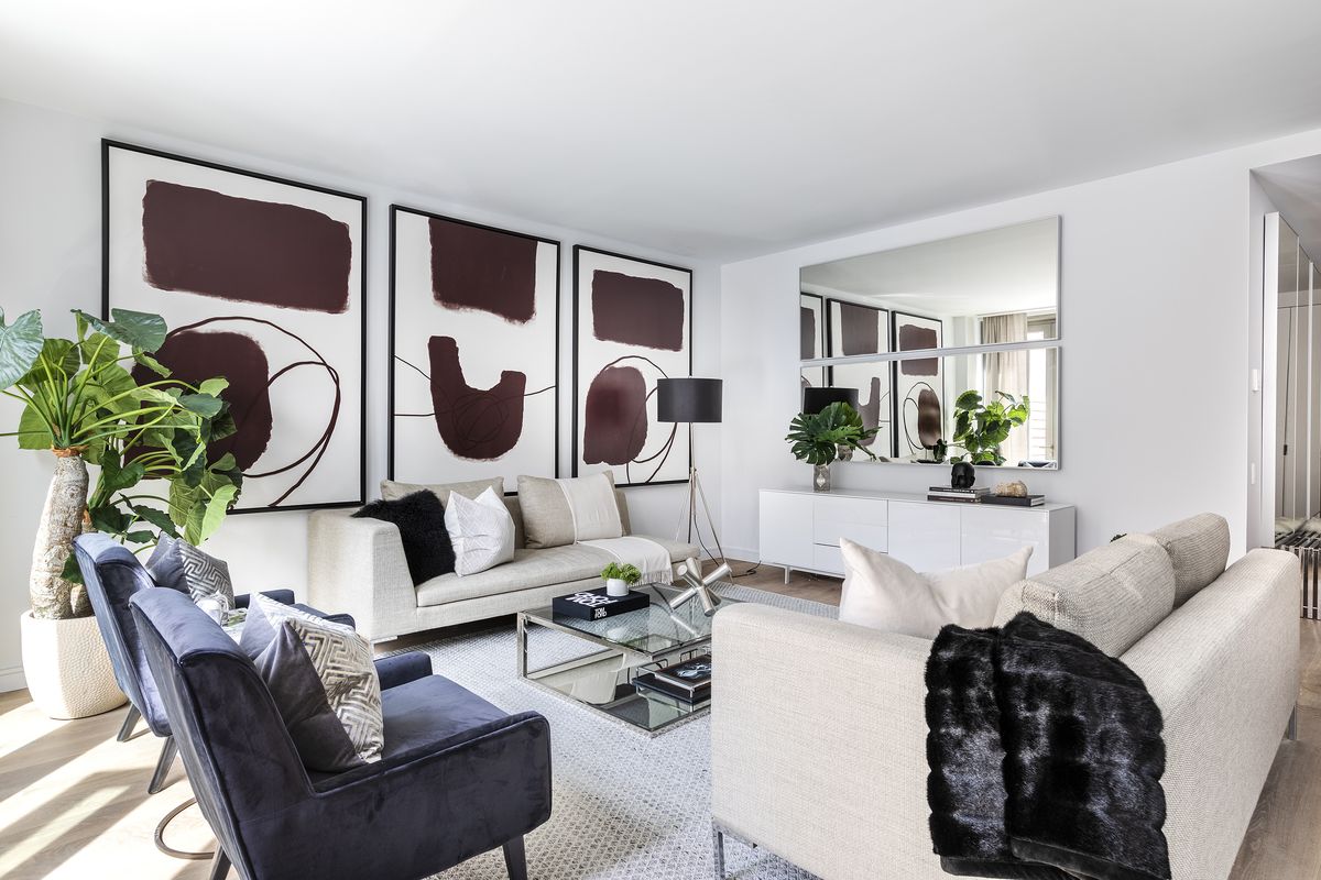 Two one-arm sofas create a sense of symmetry in this modern living room.  (Design Recipes)