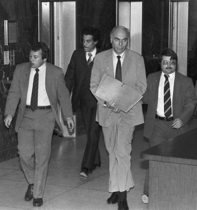 In this Jan. 22, 1983, photo, ex-CIA agent Edwin Wilson, center, leaves federal court in Houston after a day of jury selection, accompanied by U.S. marshals. (Associated Press)