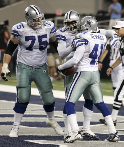 Marc Colombo (75) and Gerald Sensabaugh help Terence Newman celebrate fourth-quarter TD. (Associated Press / The Spokesman-Review)