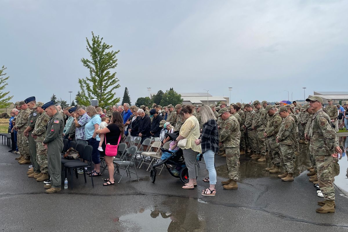 Attendees bow their heads in prayer during the 100th anniversary celebration of the 116th Air Refueling Squadron Sunday morning at Fairchild Air Force Base.  (Garrett Cabeza / The Spokesman-Review)