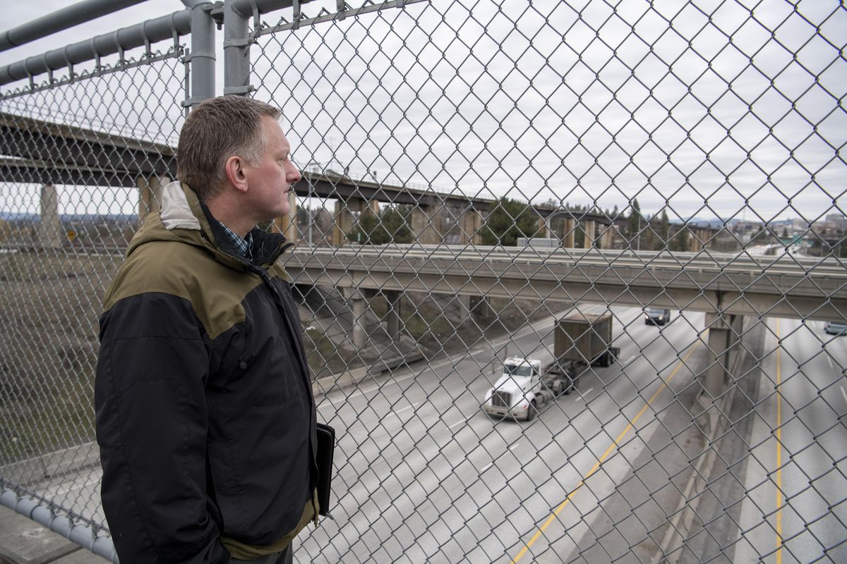 Transportation planner Ryan Stewart of the Spokane Regional Transportation Council stands on the Fish Lake Trail overpass above I-90 on Tuesday. Stewart is overseeing a study bringing together SRTC partners to discuss the nearby I-90/U.S. 195 interchange. (Jesse Tinsley / The Spokesman-Review)