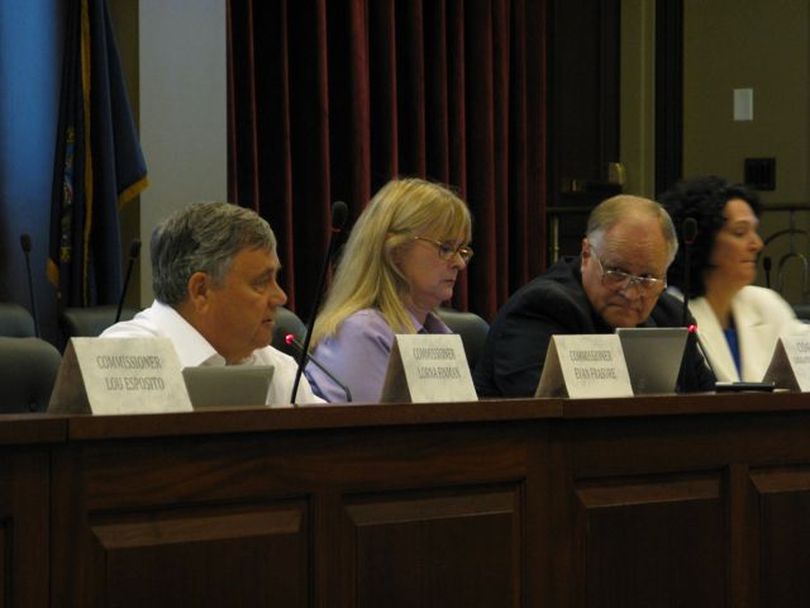 Idaho Redistricting Commission co-chairman Evan Frasure, left, and Allen Andersen, right, talk during the commission's meeting Tuesday morning; at center is commission secretary Cyd Gaudet. (Betsy Russell)