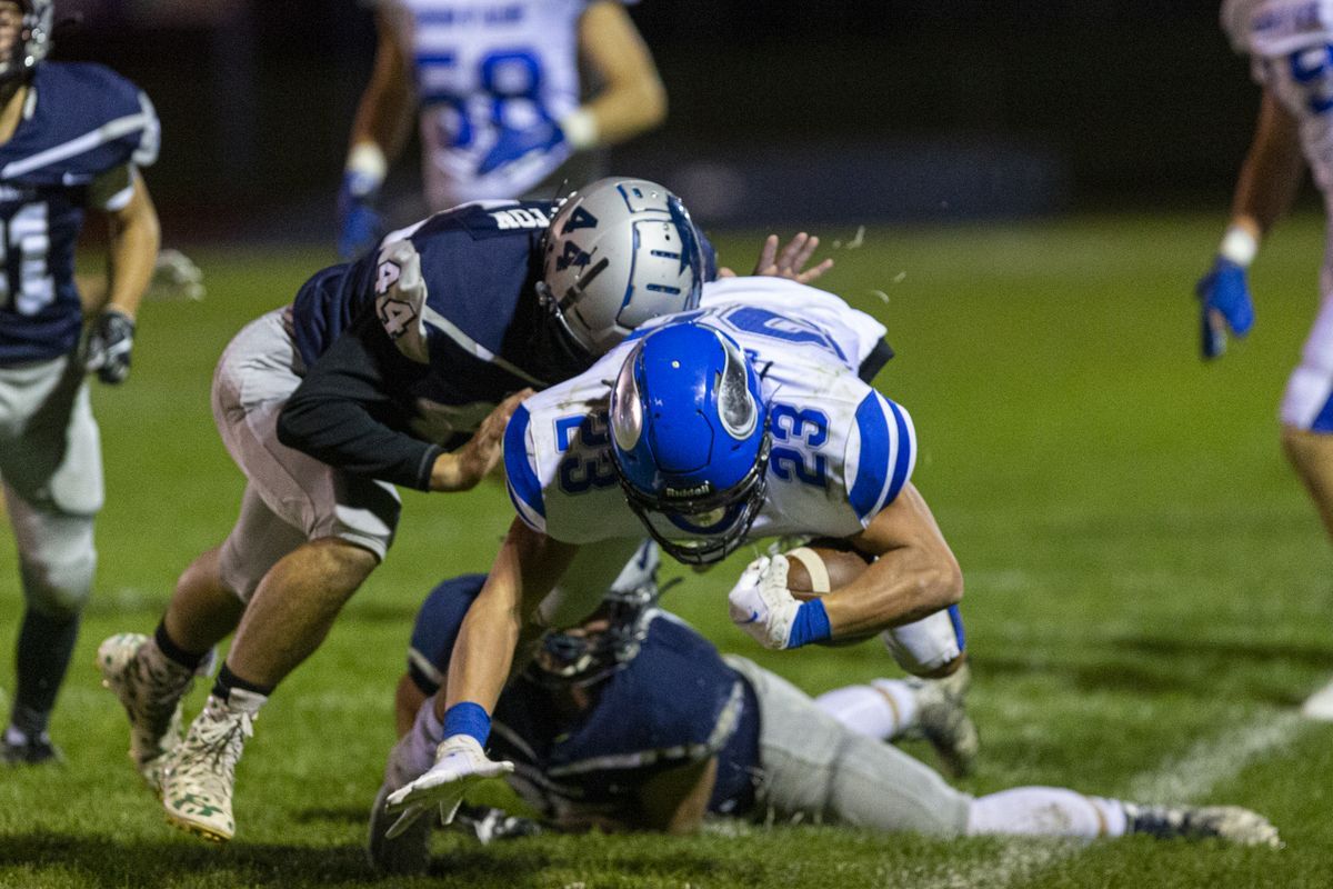 Coeur d’Alene running back Gunner Giulio fights for yardage in 40-13 win over host Lake City on Sept. 25, 2020.  (Cheryl Nichols/For The Spokesman-Review)