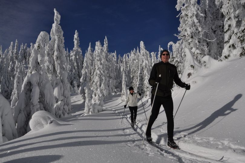 Brian and Ann Grow leave the groomed trails behind to enjoy some old-style skiing on skier-made tracks around Shadow Mountain on a brilliant Saturday at Mount Spokane State Park. (Rich Landers)